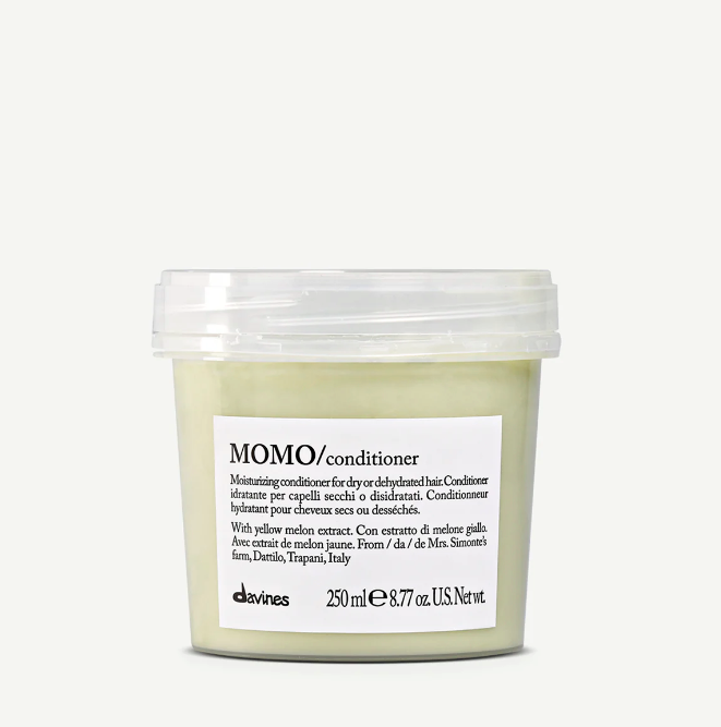 A clear plastic container of MOMO moisturizing conditioner by davines, with a label that includes the product name and a brief description.