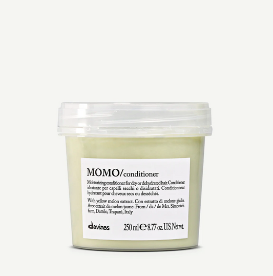 A clear plastic container of MOMO moisturizing conditioner by davines, with a label that includes the product name and a brief description.