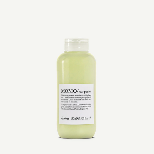 A bottle of MOMO Hair Potion, a moisturizing hair lotion by Davines. The bottle is clear with a white label and cap, and it contains a light green liquid.